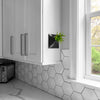 6 inch black wall planter with air plant in white modern kitchen.